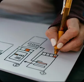 Designer sketching a mobile layout for an inclusive and accessible educational application.
